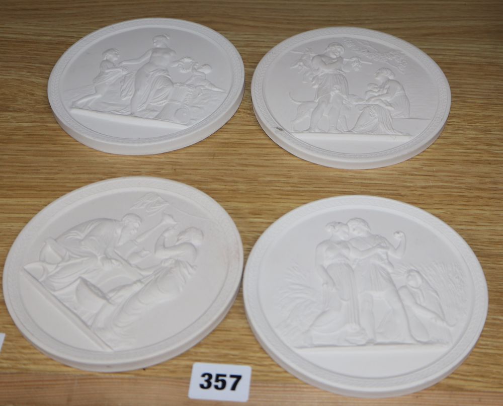 A set of four classical plaster wall plaques, diameter 13.5cm